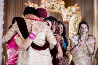 Family hugging after wedding ceremony