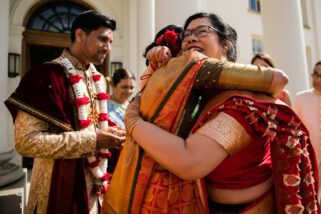 Mothers of wedding couple hugging