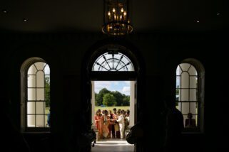 Wedding party walking into Hylands House