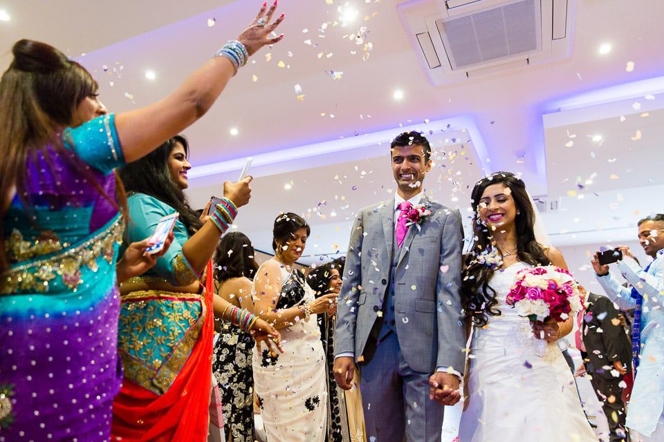 Bride and Groom being showered with confetti