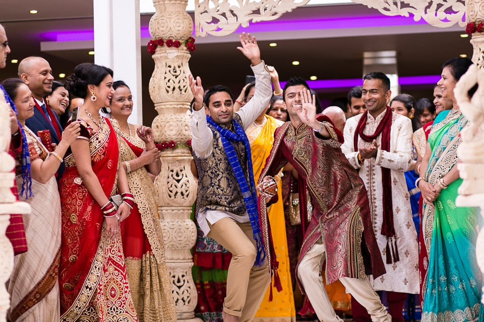 Hindu groom dancing up the isle way