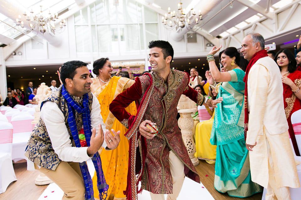 Hindu groom dancing up the isle way