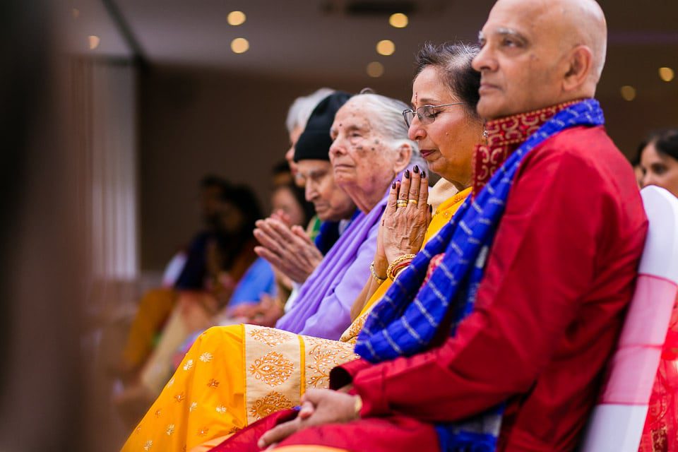 Asian wedding guests praying