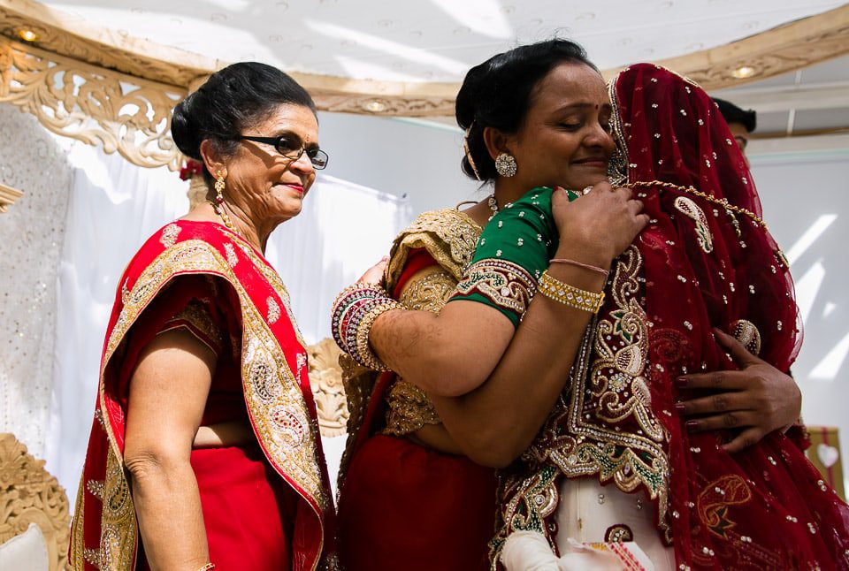 Bride hugging family members