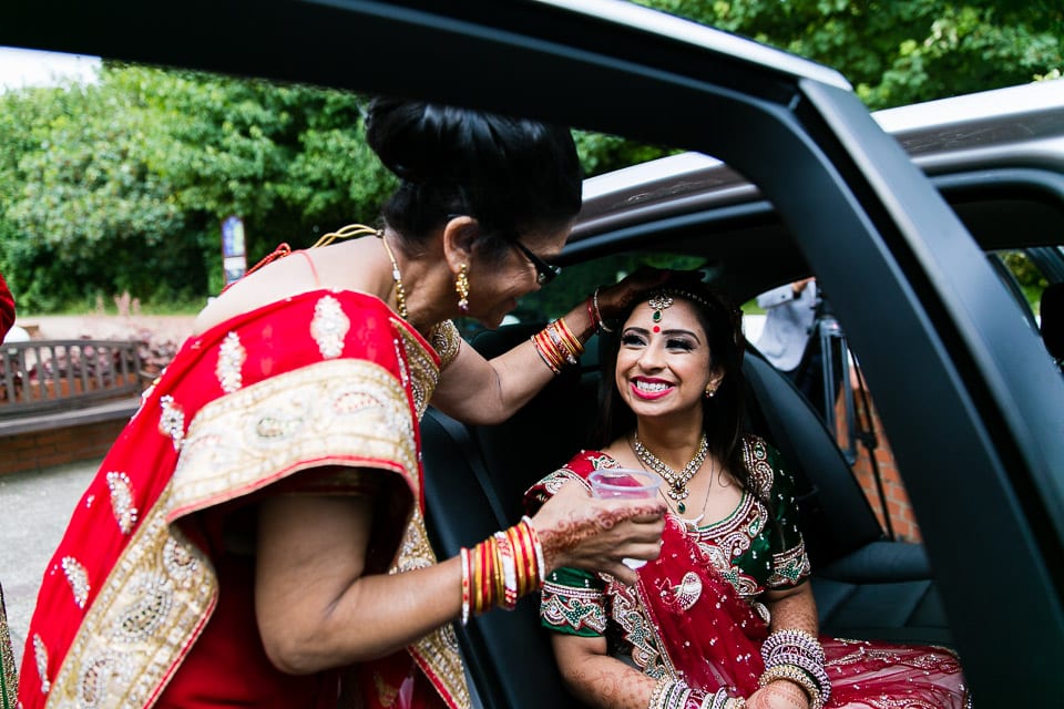 Hindu bride smiling at mother