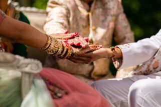 Parents of the bride holding the wedding couple's hands