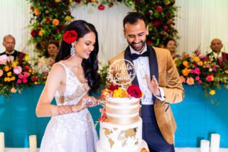 Asian wedding couple cutting their wedding cake