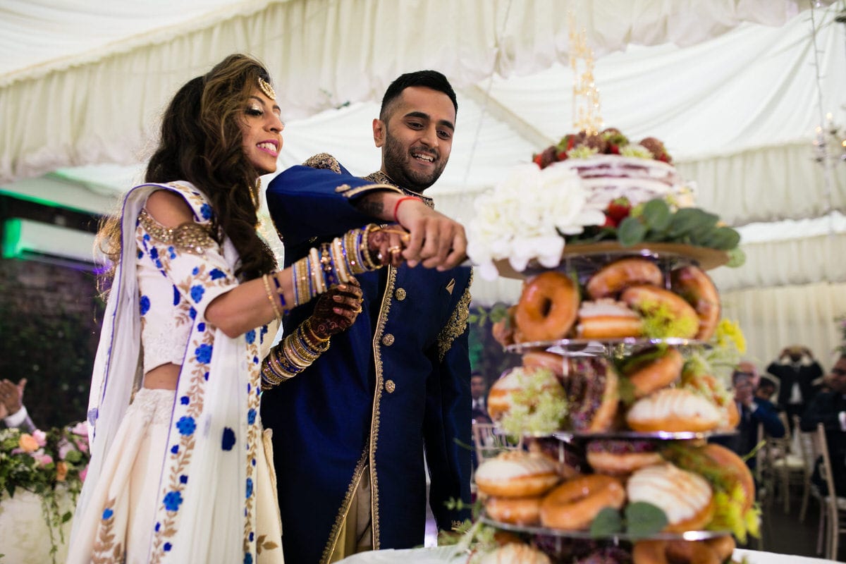 Bride and groom cutting their wedding cake