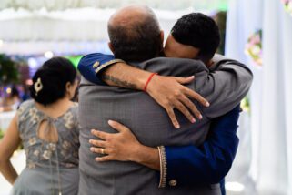 Groom hugging parents