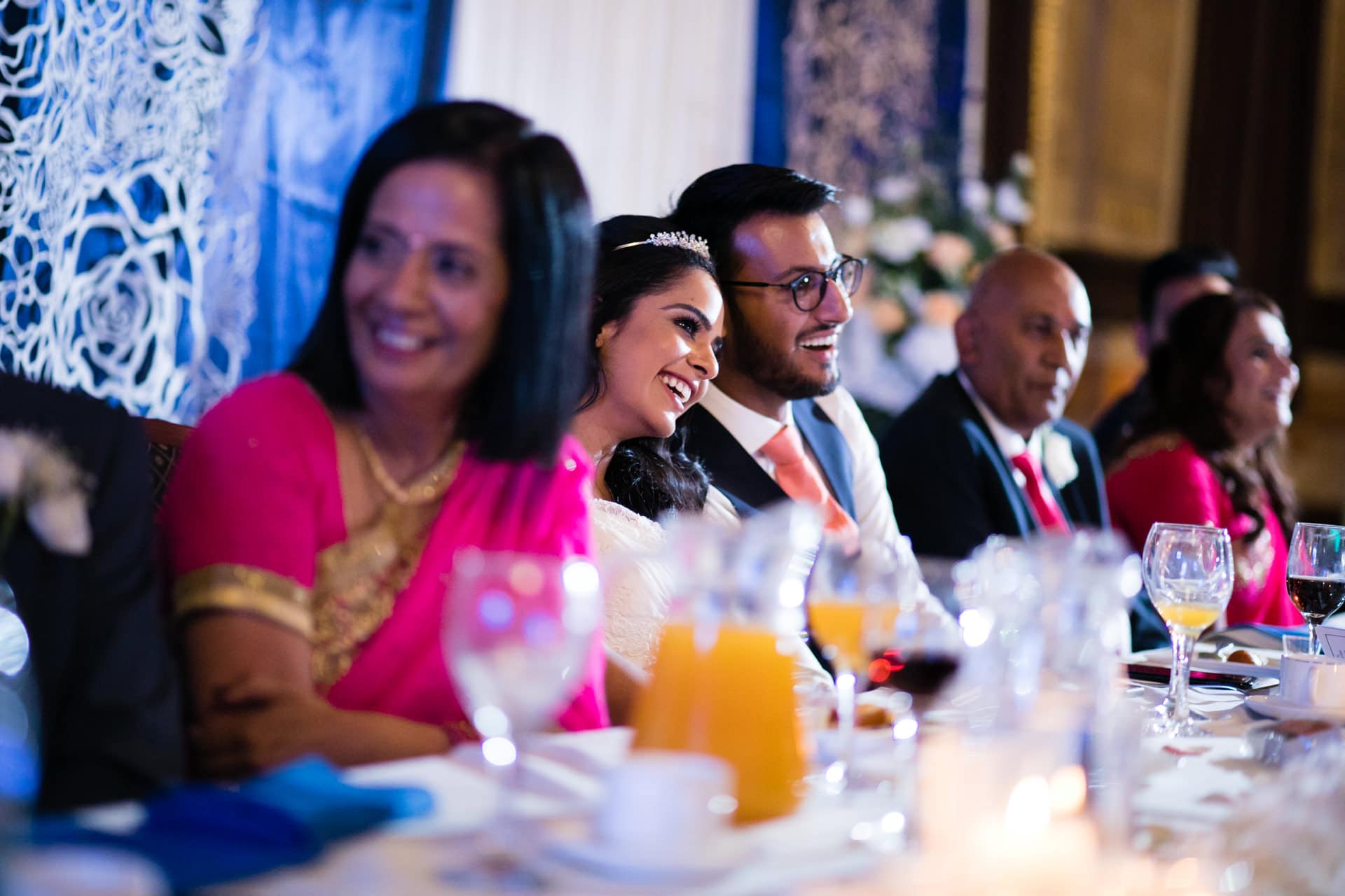 Bride and groom laughing during speeches