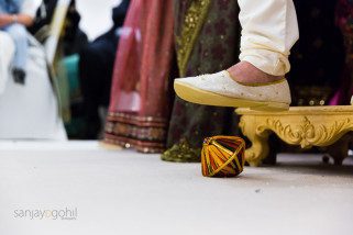 Groom stepping on clay pot during Hindu Wedding ceremony