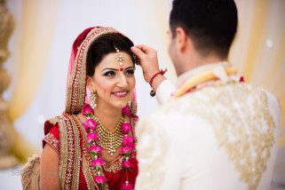 Sindoor being placed onto the forehead of the bride