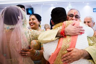 bride and groom hugging parents