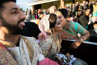 Mother kissing bride on the cheek