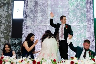 Bride and groom getting on the table