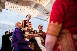 Groom being lifted by best men