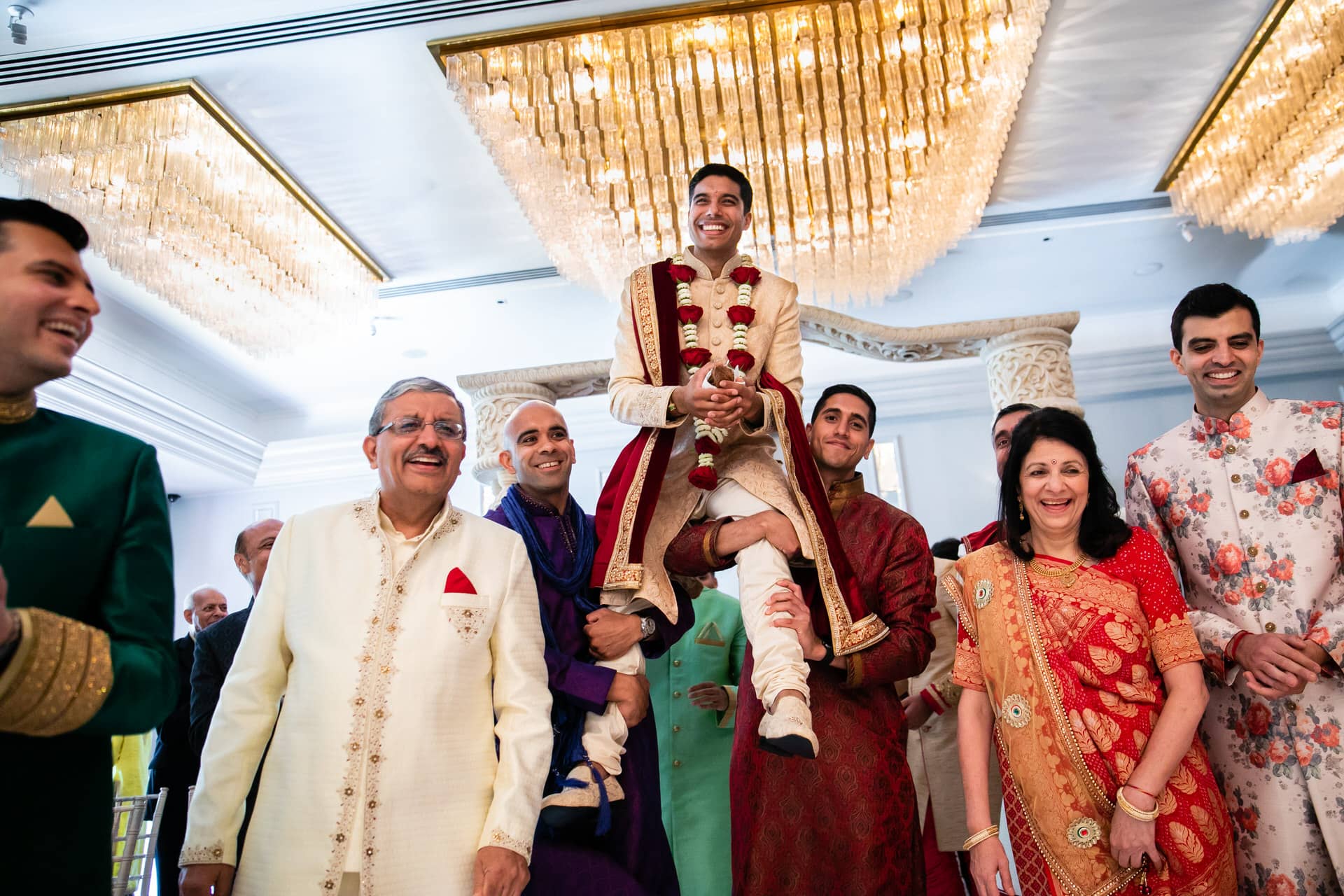 Groom being lifted by best men