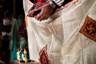 Seeds being poured into the fire during asian wedding ceremony