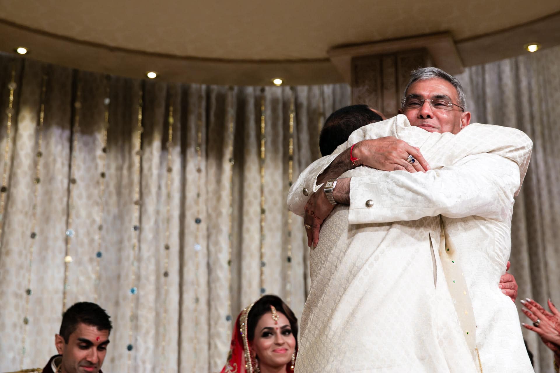 Fathers of bride and groom hugging