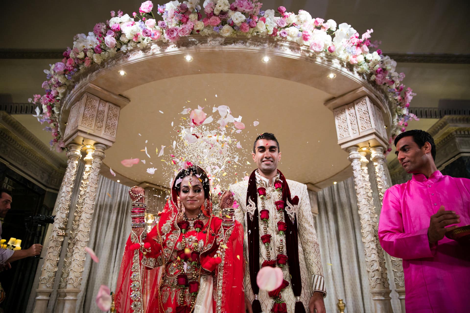 Bride throwing rice and flowers to close the Mandap 