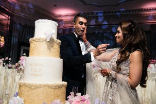 Asian wedding couple by the cake