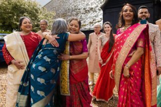 Mothers of the bride and groom hugging