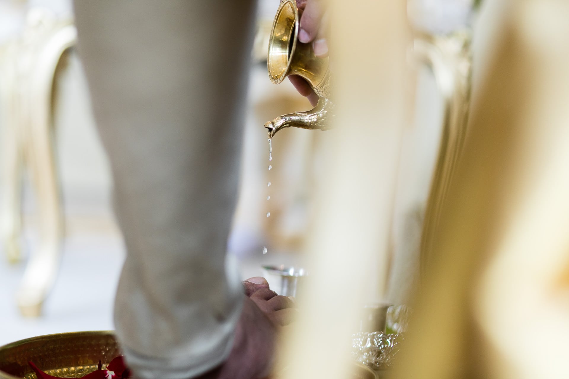 Water being poured onto the feet of the groom