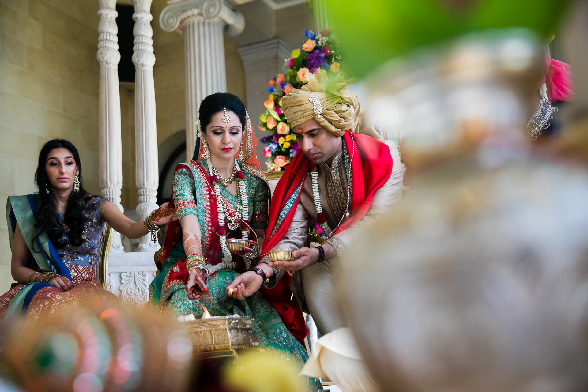 Hindu Wedding couple offering seeds into the fire