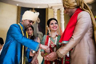 Brother of bride offering seeds to bride and groom