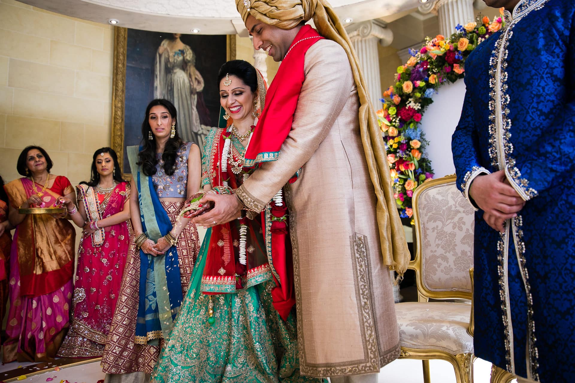 Bride and groom pouring seeds into the Havan