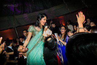 Asian wedding guests dancing during reception party at Saville Court