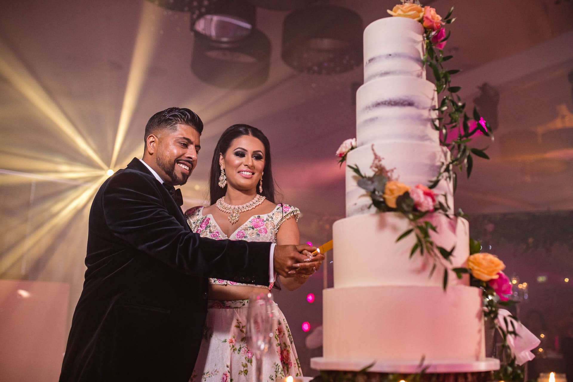 Bride and groom cutting wedding cake