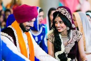 Bride and Groom laughing after sikh wedding ceremony
