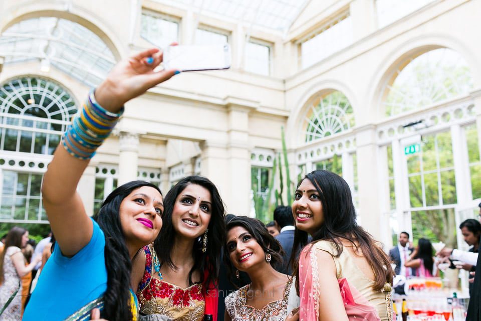 Asian Wedding guests taking a selfie