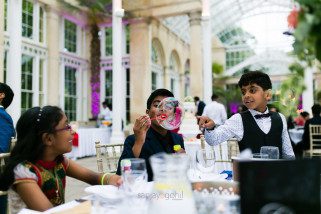 Children blowing bubbles during reception party