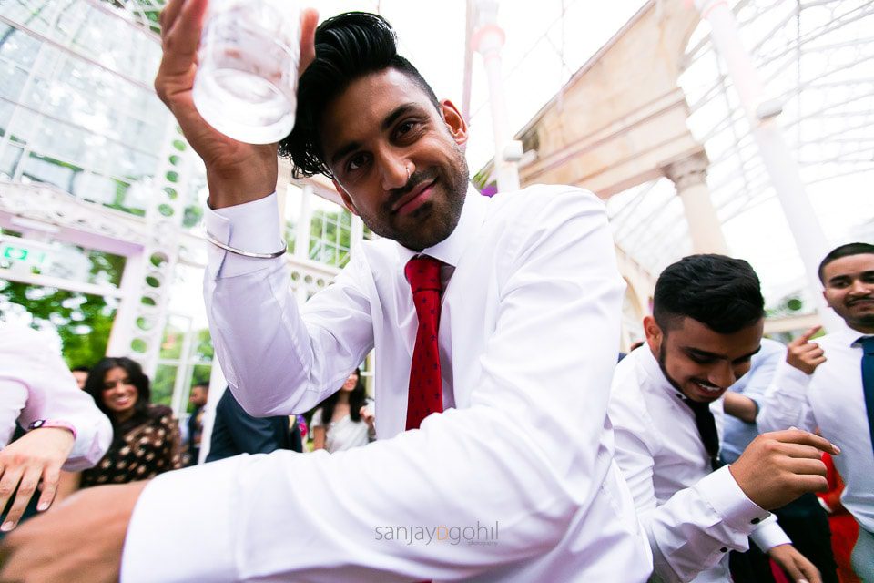 Asian Wedding guests dancing during reception party at Syon Conservatory