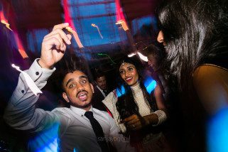 Asian Wedding guests dancing during reception party at Syon Conservatory