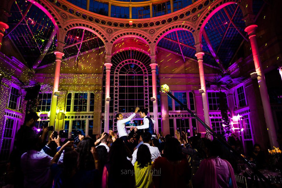 Asian Wedding guests dancing during reception party at Syon Conservatory