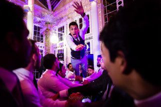 Asian Wedding guests dancing during reception party at Syon Conservatory