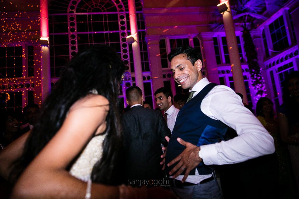 Asian Wedding guests dancing during reception party at Syon Conservatory