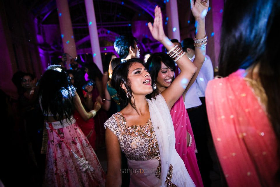 Asian Wedding guests dancing during reception party at Syon Conservatory