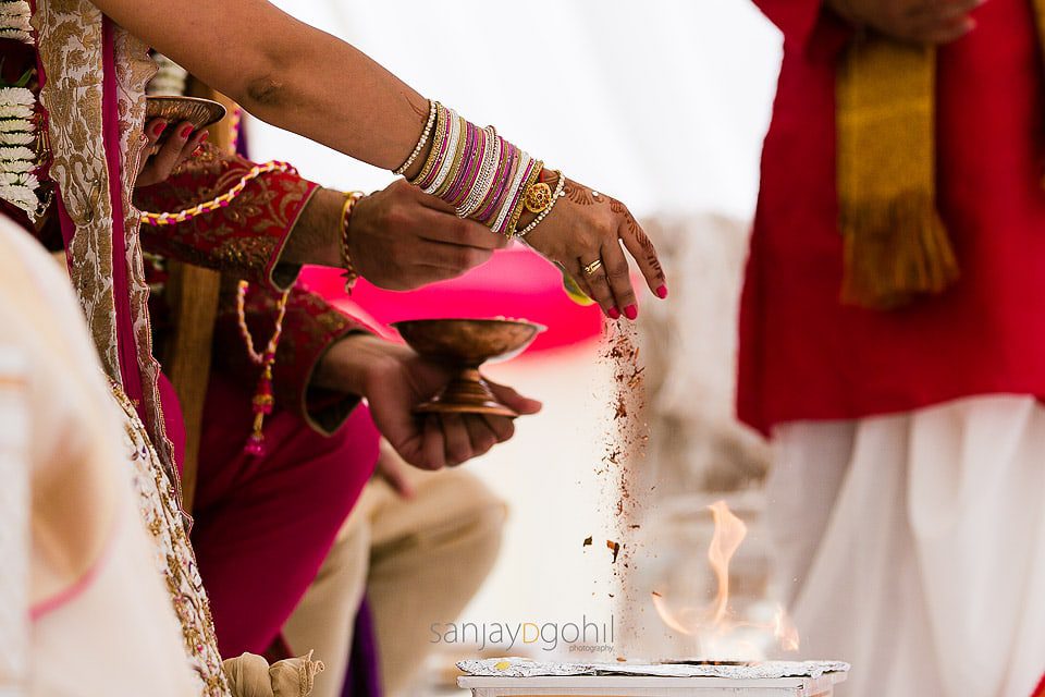 Seeds being poured into the fire during Hindu wedding ceremony