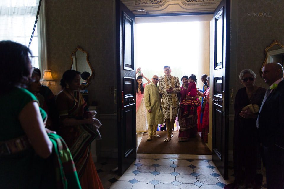 Wedding groom walkinginto Hedsor House