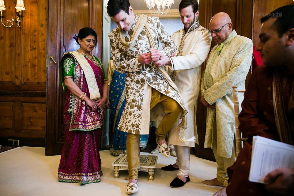 Groom stepping on clay pot during Hindu Wedding