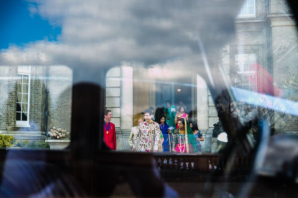 Bride and groom through the window of the car