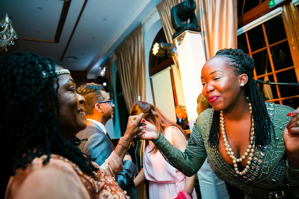 Wedding guests dancing during reception party at Hedsor House