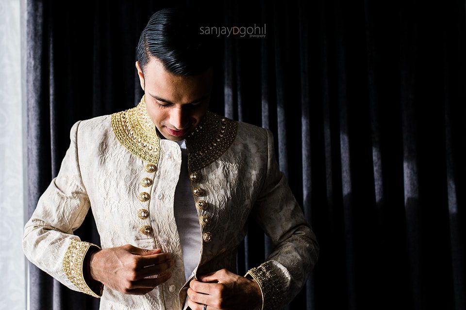 Asian wedding groom getting ready