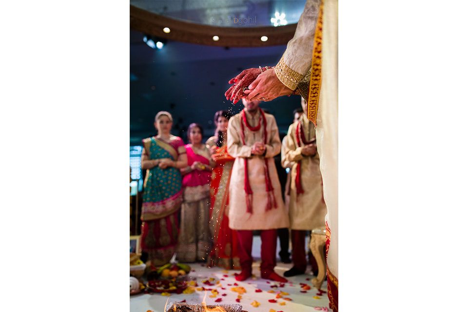 Seeds being poured into the fire during asian wedding ceremony