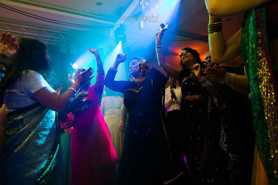 Asian wedding guests dancing