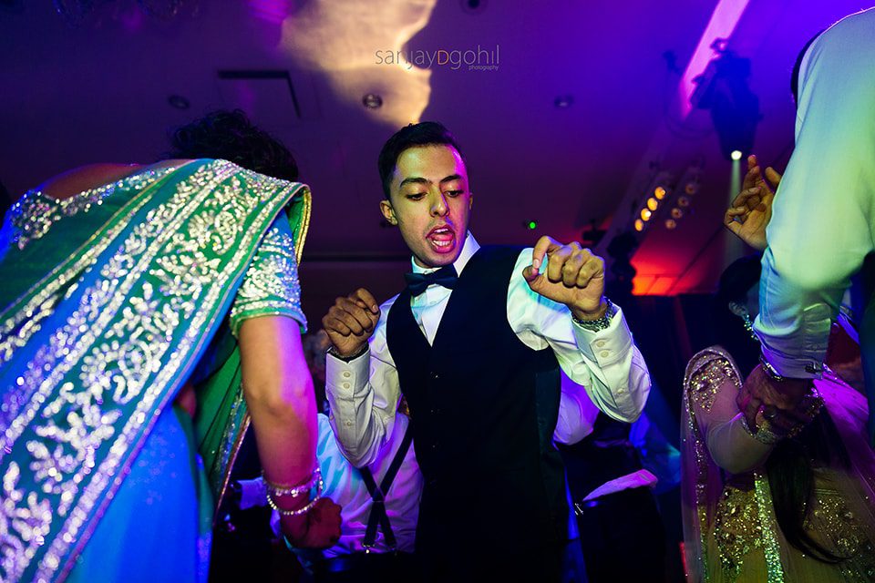 Asian wedding guests dancing